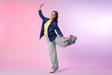 Photo of Girl in stylish clothes dancing on color background