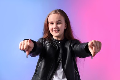Photo of Girl in stylish clothes dancing on color background