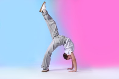 Photo of Girl in stylish clothes dancing on color background