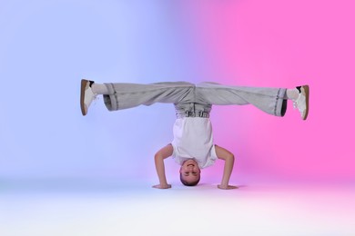 Photo of Girl in stylish clothes dancing on color background