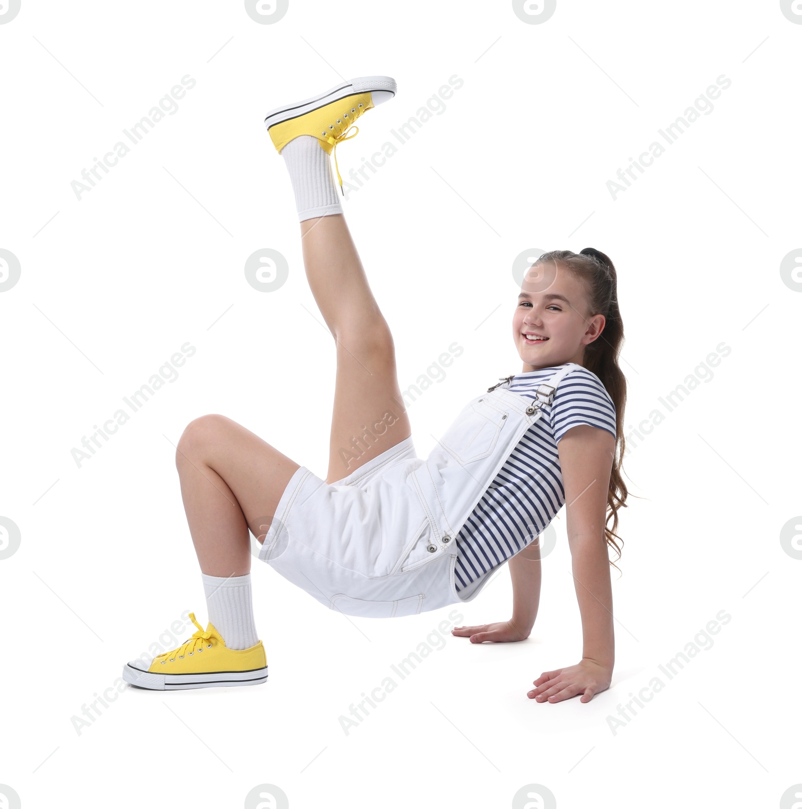 Girl in stylish clothes dancing on white background Photo of Girl in stylish clothes dancing on white background