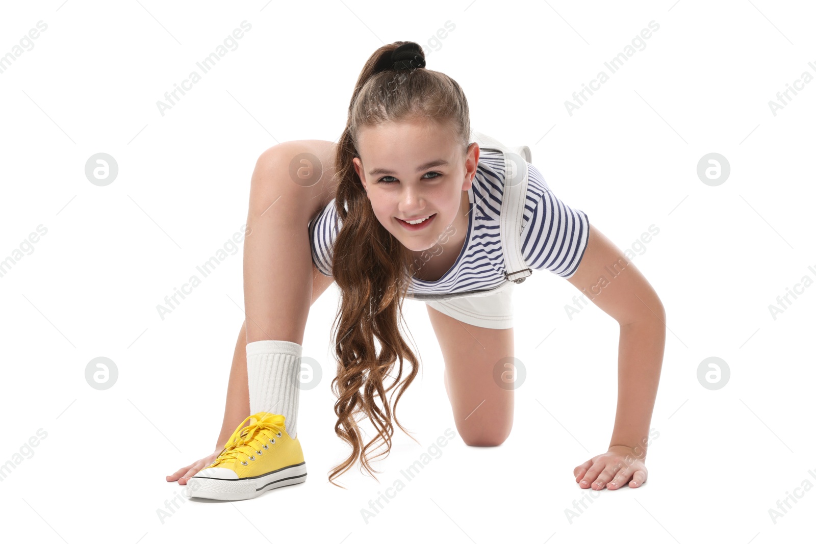 Girl in stylish clothes dancing on white background Photo of Girl in stylish clothes dancing on white background
