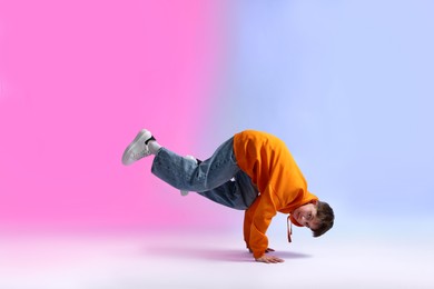 Photo of Boy in stylish clothes dancing on color background