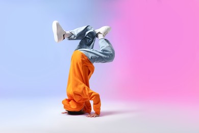 Photo of Boy in stylish clothes dancing on color background