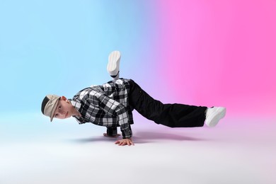 Photo of Boy in stylish clothes dancing on color background