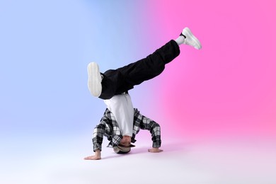 Photo of Boy in stylish clothes dancing on color background