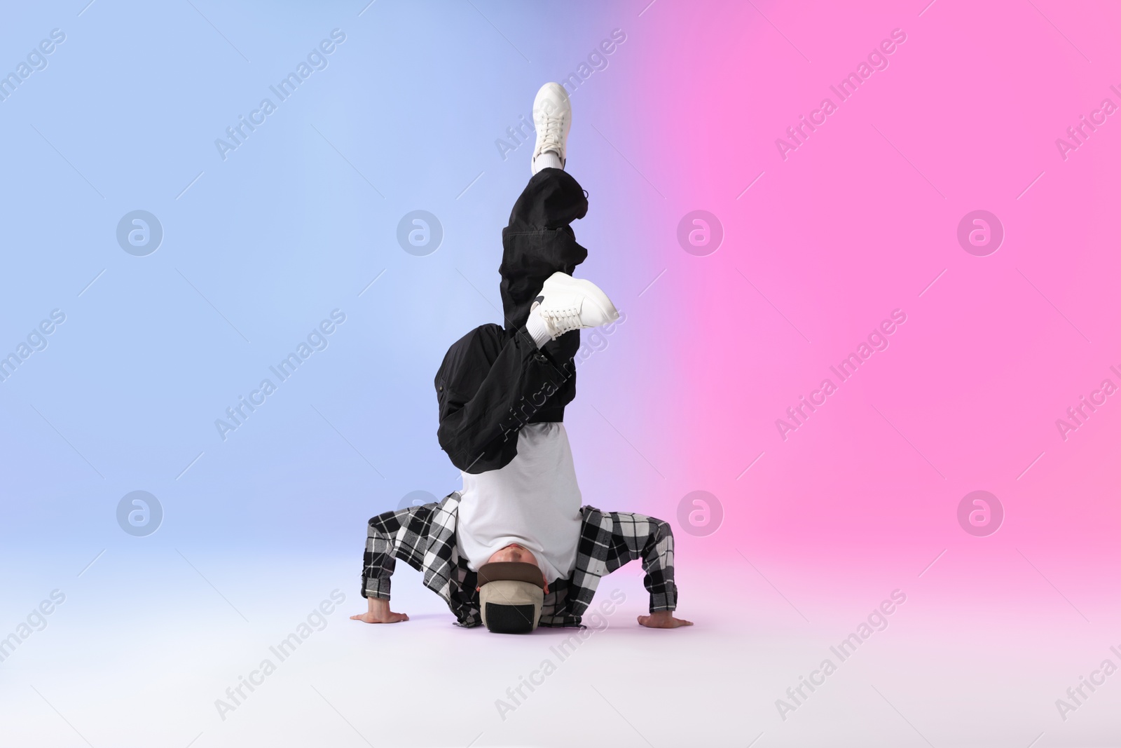 Photo of Boy in stylish clothes dancing on color background