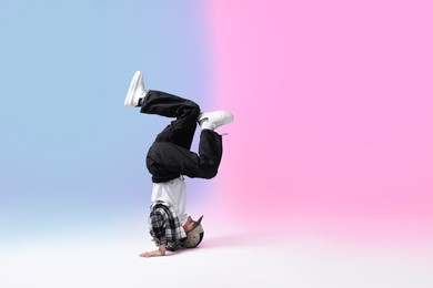 Photo of Boy in stylish clothes dancing on color background, space for text