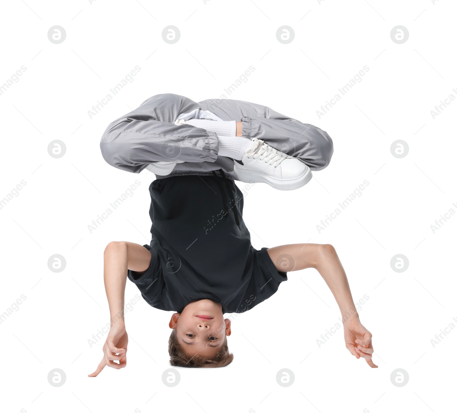 Boy in stylish clothes dancing on white background Photo of Boy in stylish clothes dancing on white background
