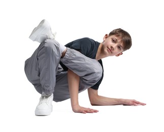 Photo of Boy in stylish clothes dancing on white background