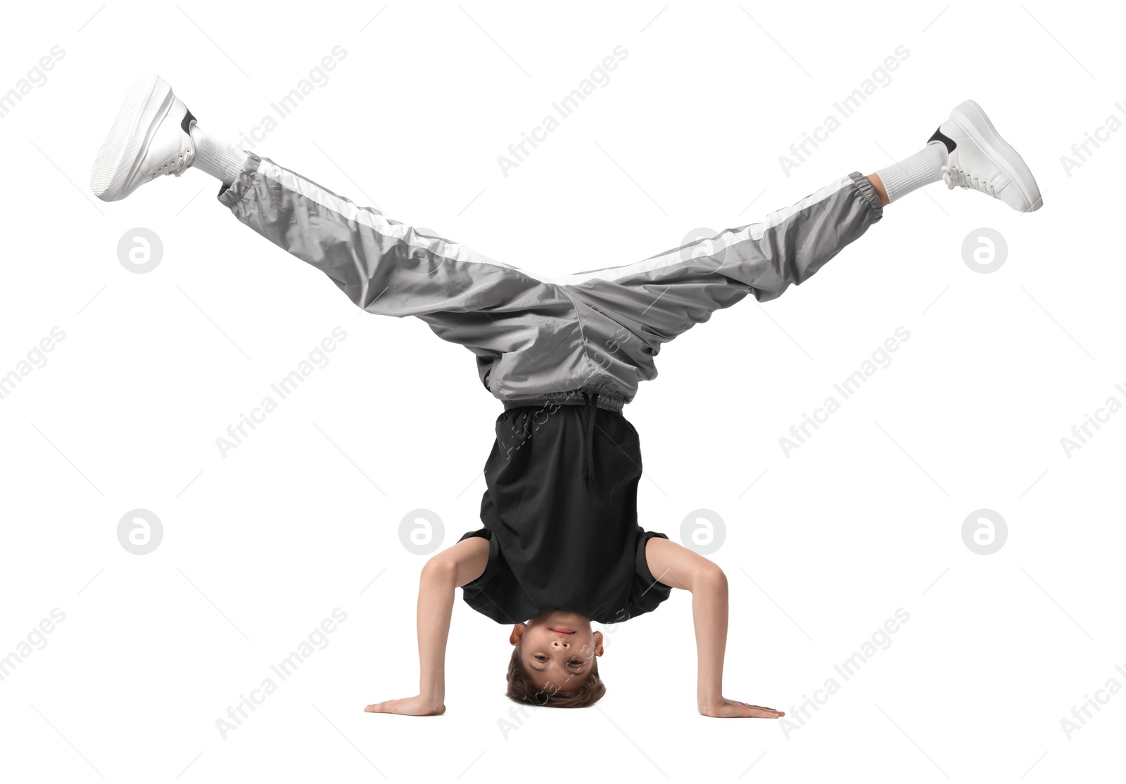 Photo of Boy in stylish clothes dancing on white background