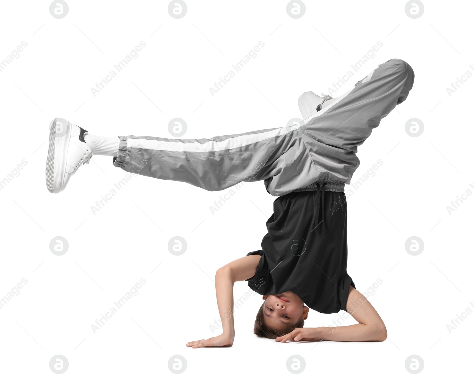 Photo of Boy in stylish clothes dancing on white background