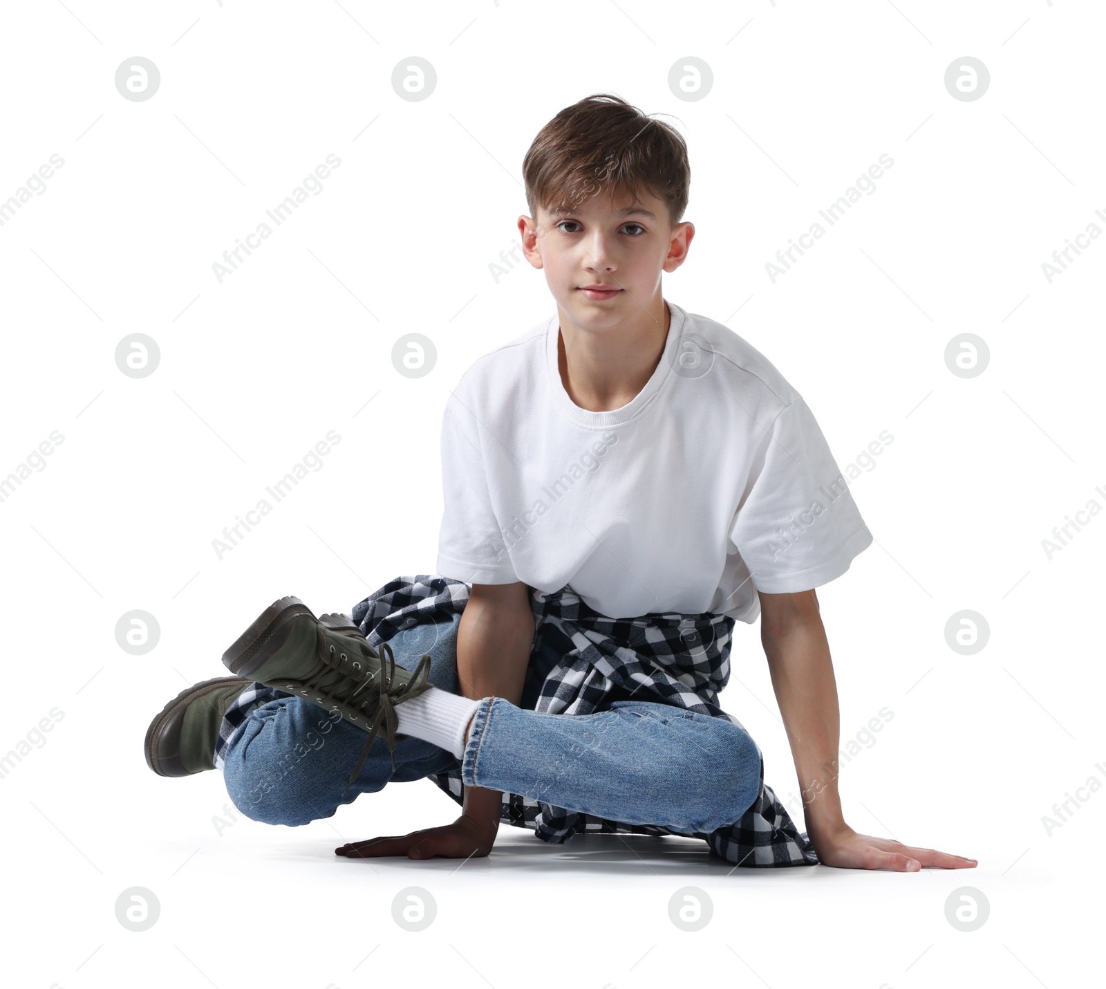 Boy in stylish clothes dancing on white background Photo of Boy in stylish clothes dancing on white background