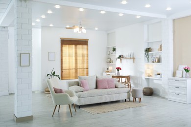 Photo of Comfortable sofa with cushions in room. Interior design