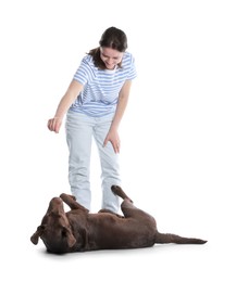 Photo of Happy woman training her dog on white background