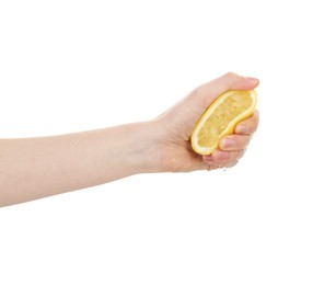 Photo of Woman squeezing lemon on white background, closeup