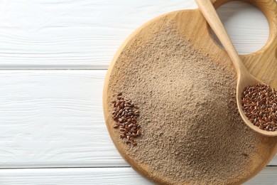 Photo of Flaxseed flour and spoon with seeds on white wooden table, top view. Space for text