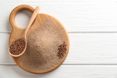 Photo of Flaxseed flour and spoon with seeds on white wooden table, top view. Space for text