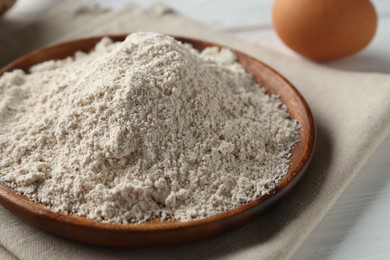Photo of Pile of flour and egg on table, closeup