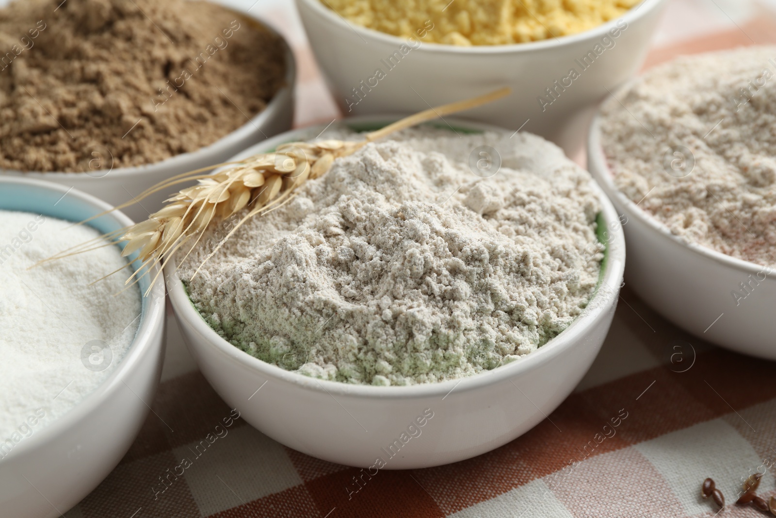 Different types of flour in bowls on table, closeup Photo of Different types of flour in bowls on table, closeup