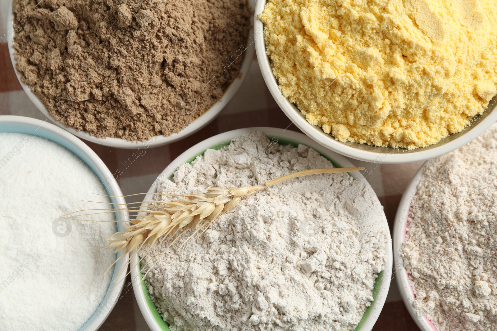 Different types of flour in bowls on table, top view Photo of Different types of flour in bowls on table, top view