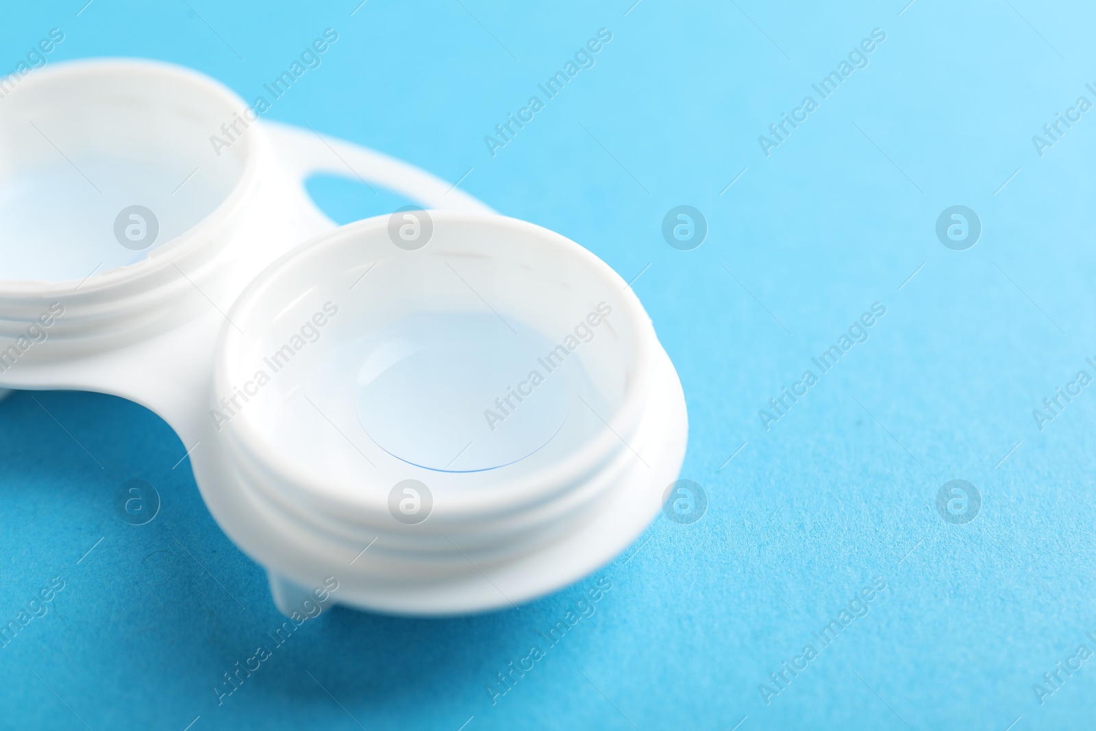 Contact lenses in case on light blue background, closeup. Space for text Photo of Contact lenses in case on light blue background, closeup. Space for text