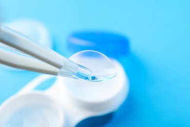 Photo of Taking contact lens from case on light background, closeup. Space for text