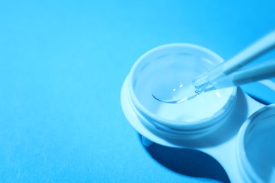Photo of Taking contact lens from case on light background, closeup. Space for text