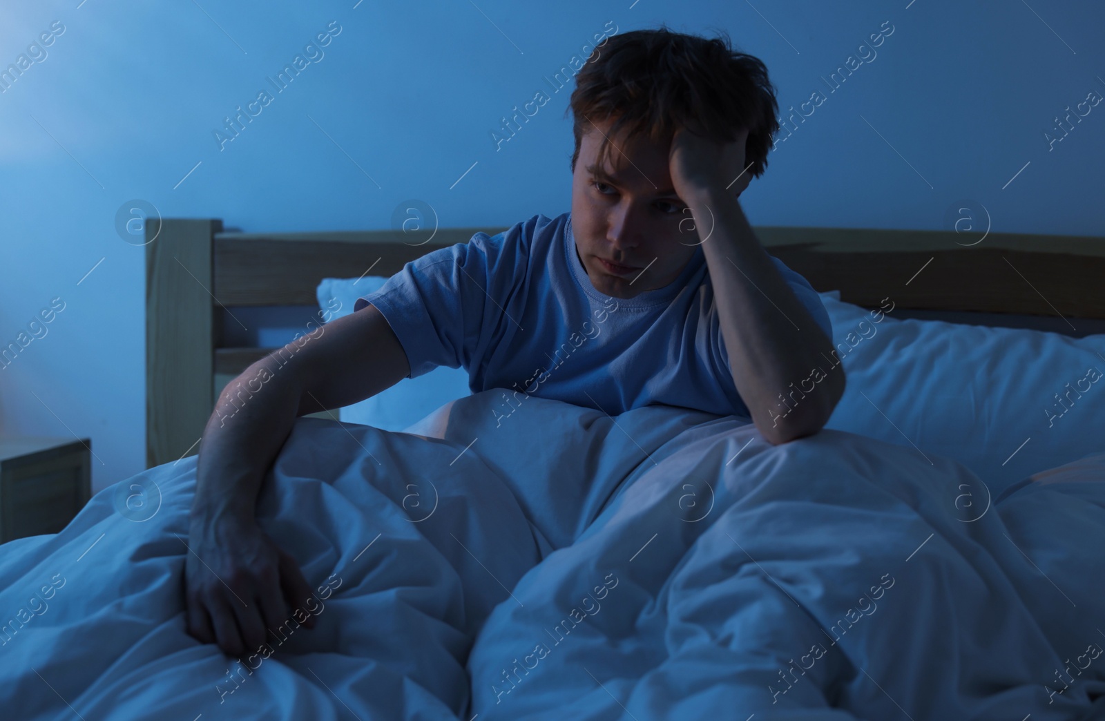 Frustrated man suffering from insomnia in bed indoors Photo of Frustrated man suffering from insomnia in bed indoors