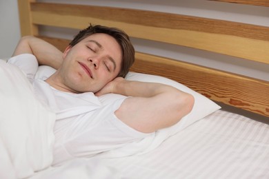 Photo of Young man sleeping in bed at home