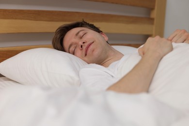 Photo of Young man sleeping in bed at home