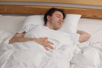 Photo of Young man sleeping in bed at home