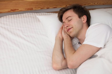 Photo of Young man sleeping in bed at home