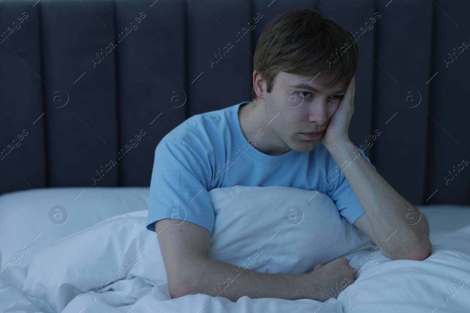 Frustrated man suffering from insomnia in bed indoors Photo of Frustrated man suffering from insomnia in bed indoors