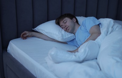 Photo of Young man sleeping in bed at home