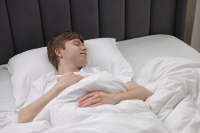 Photo of Young man sleeping in bed at home