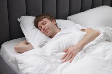 Photo of Young man sleeping in bed at home