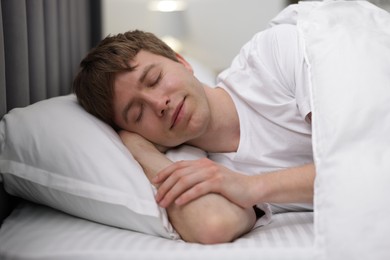 Photo of Young man sleeping in bed at home