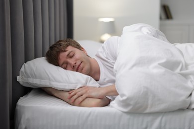 Photo of Young man sleeping in bed at home