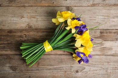 Photo of Bunch of beautiful flowers on wooden table, top view