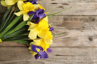 Photo of Bunch of beautiful flowers on wooden table, top view. Space for text