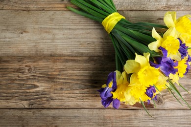 Photo of Bunch of beautiful flowers on wooden table, top view. Space for text