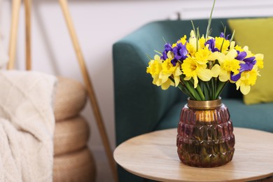 Photo of Bouquet of beautiful flowers in vase on coffee table indoors. Space for text
