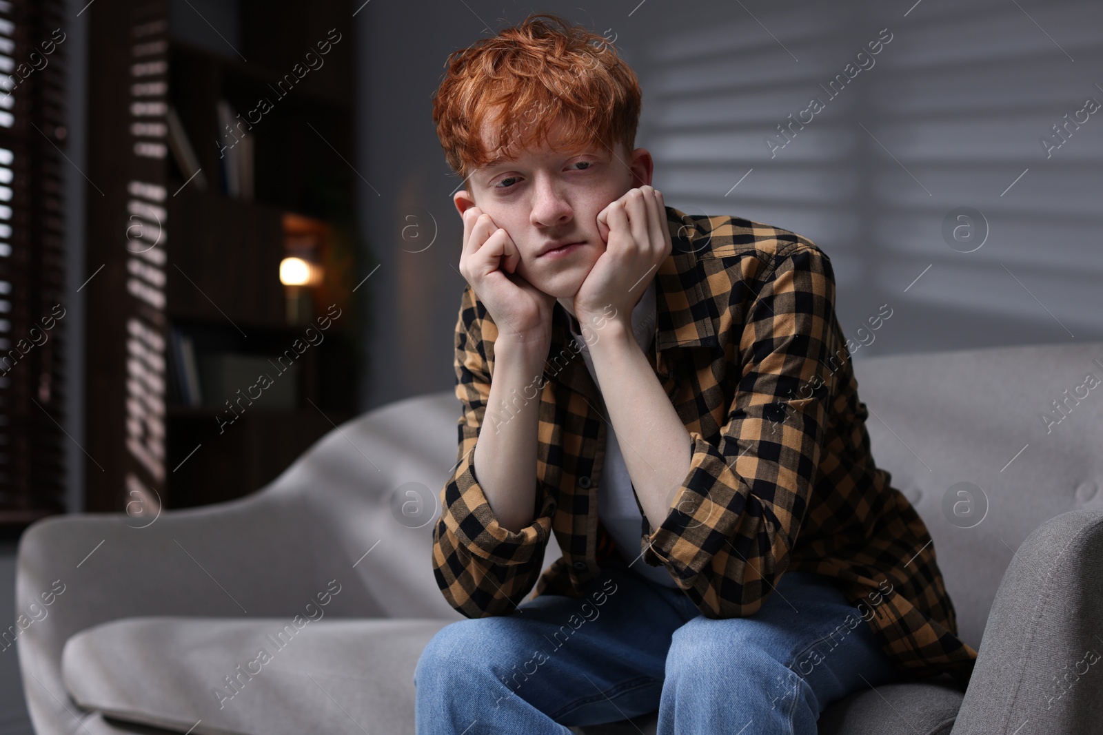 Teen problems. Depressed teenage boy on sofa at home Photo of Teen problems. Depressed teenage boy on sofa at home
