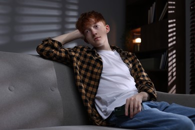Photo of Teen problems. Depressed teenage boy with smartphone at home