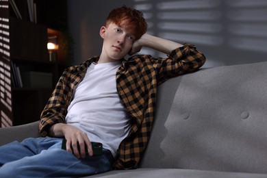 Photo of Teen problems. Depressed teenage boy with smartphone at home