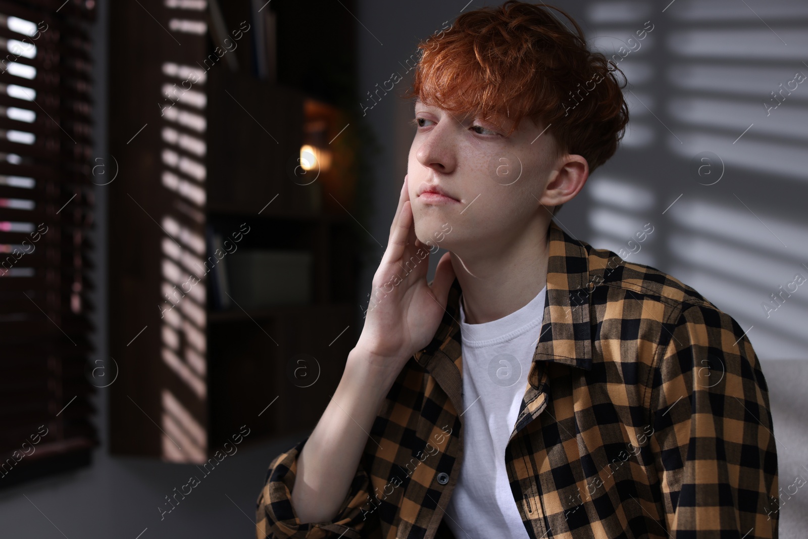 Teen problems. Depressed teenage boy at home Photo of Teen problems. Depressed teenage boy at home