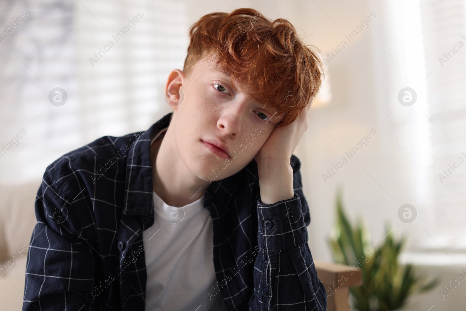 Teen problems. Depressed teenage boy at home Photo of Teen problems. Depressed teenage boy at home