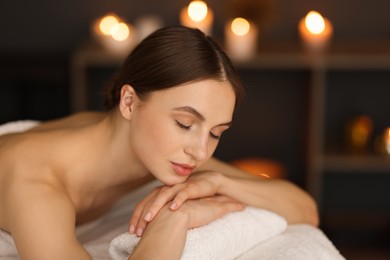 Photo of Beautiful woman relaxing in spa salon, closeup