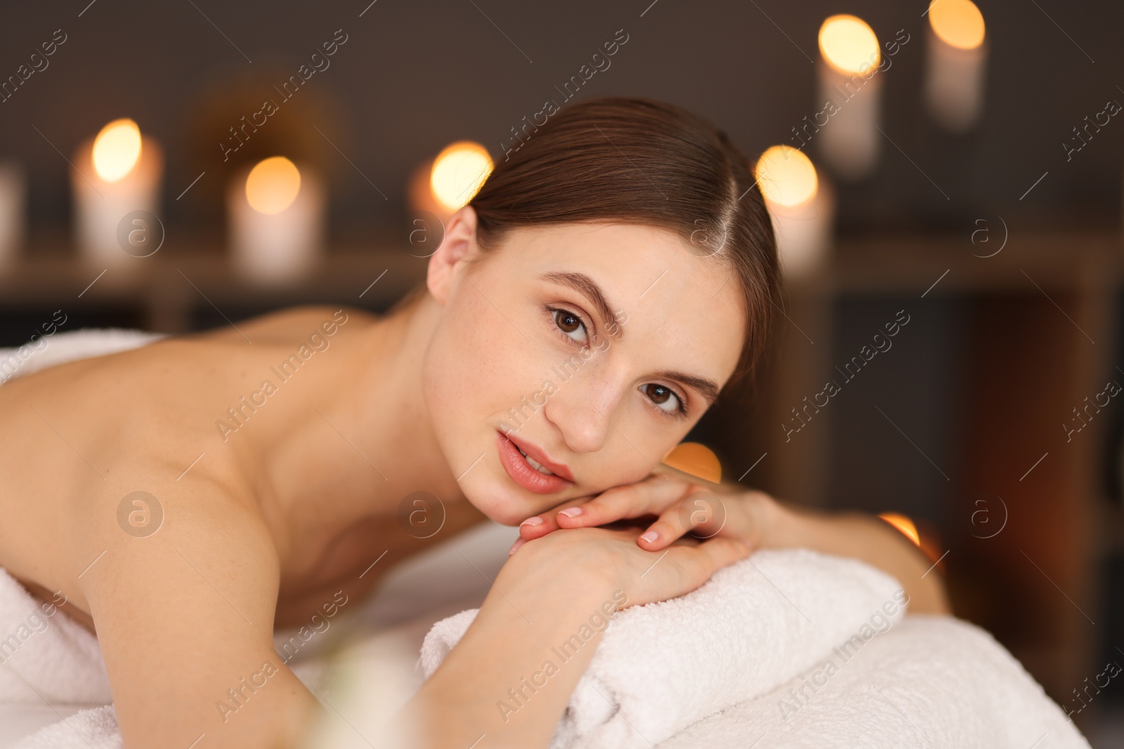 Beautiful woman relaxing on massage couch in spa salon Photo of Beautiful woman relaxing on massage couch in spa salon